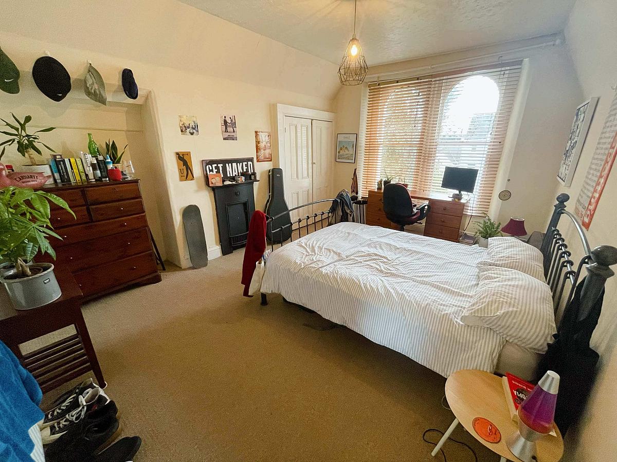 Second student bedroom with double bed, built-in wardrobe, chest of drawers and desk
