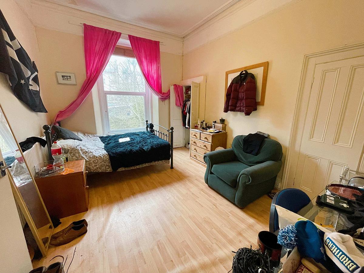 fourth student room with double bed, desk and built-in wardrobe