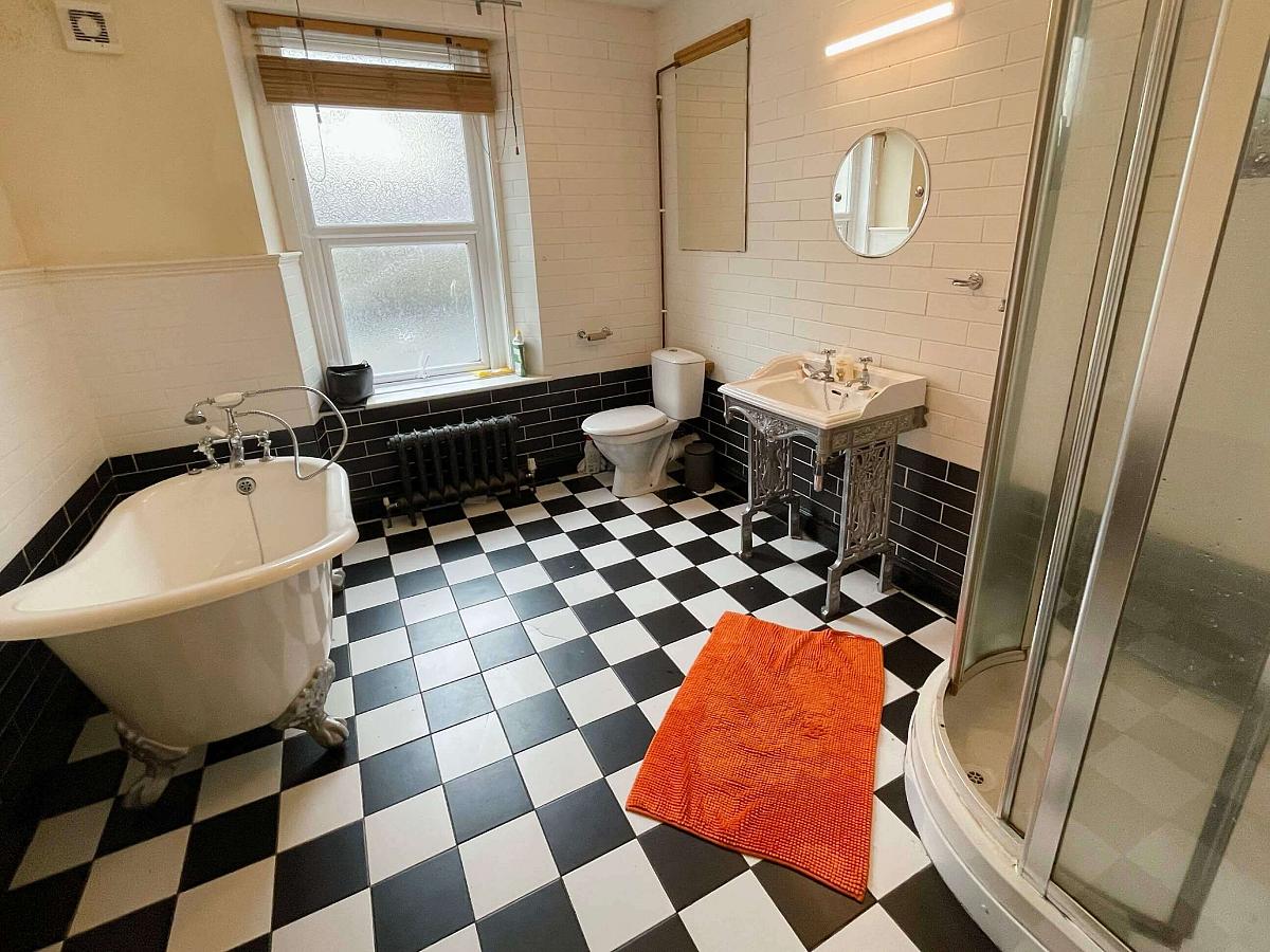 Shared bathroom with bath and shower