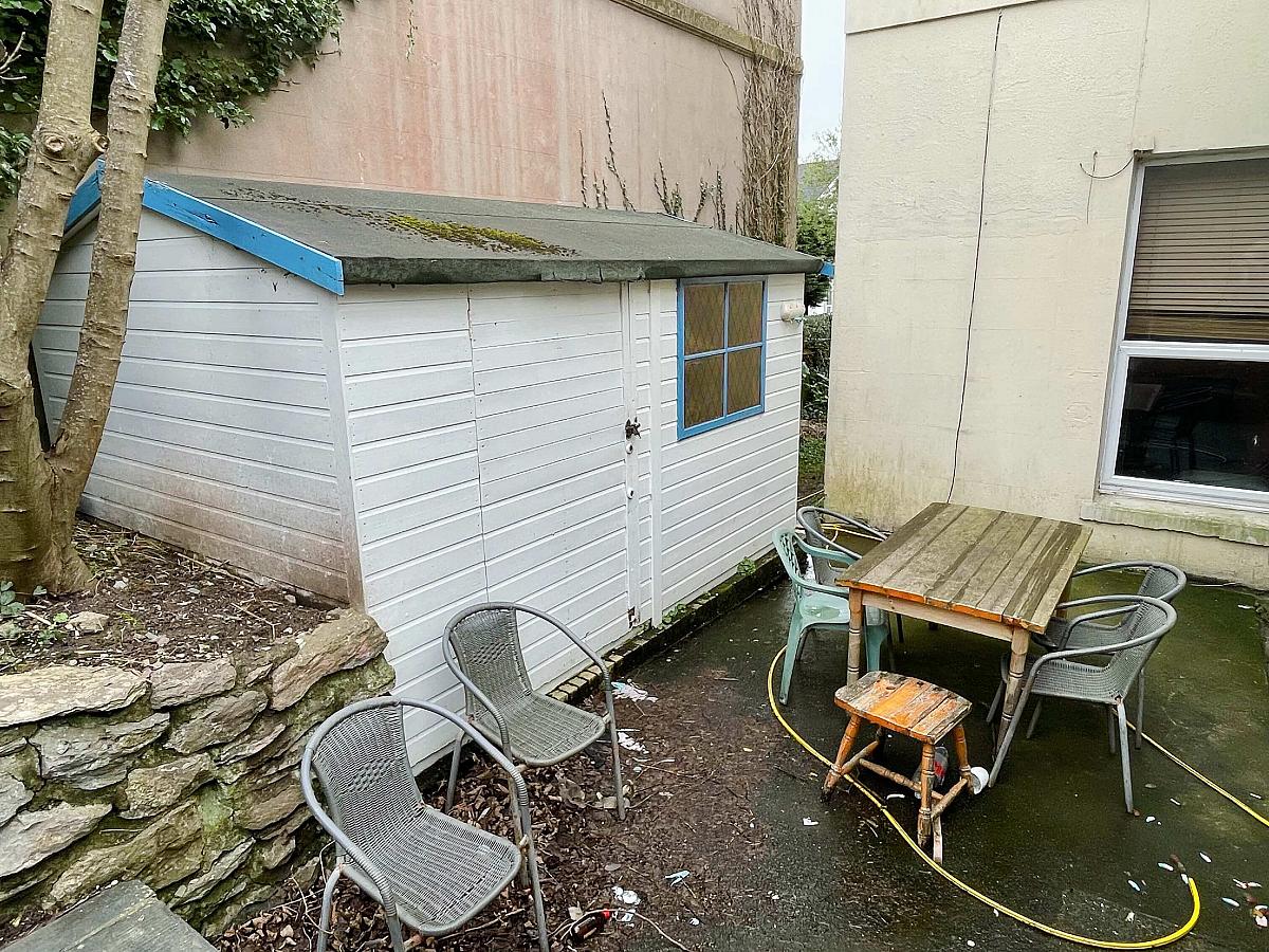 Shared back garden with furniture and shed