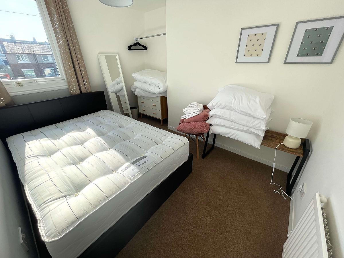 third student bedroom wit double bed and chest of drawers