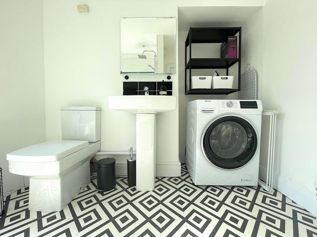 white shared bathroom with washing machine