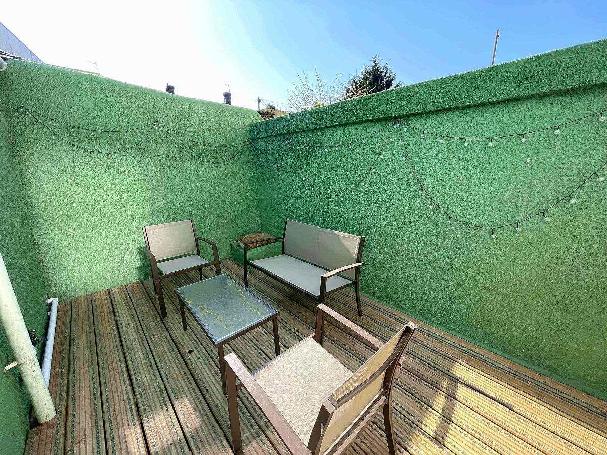 shared back garden area with decking and outside furniture