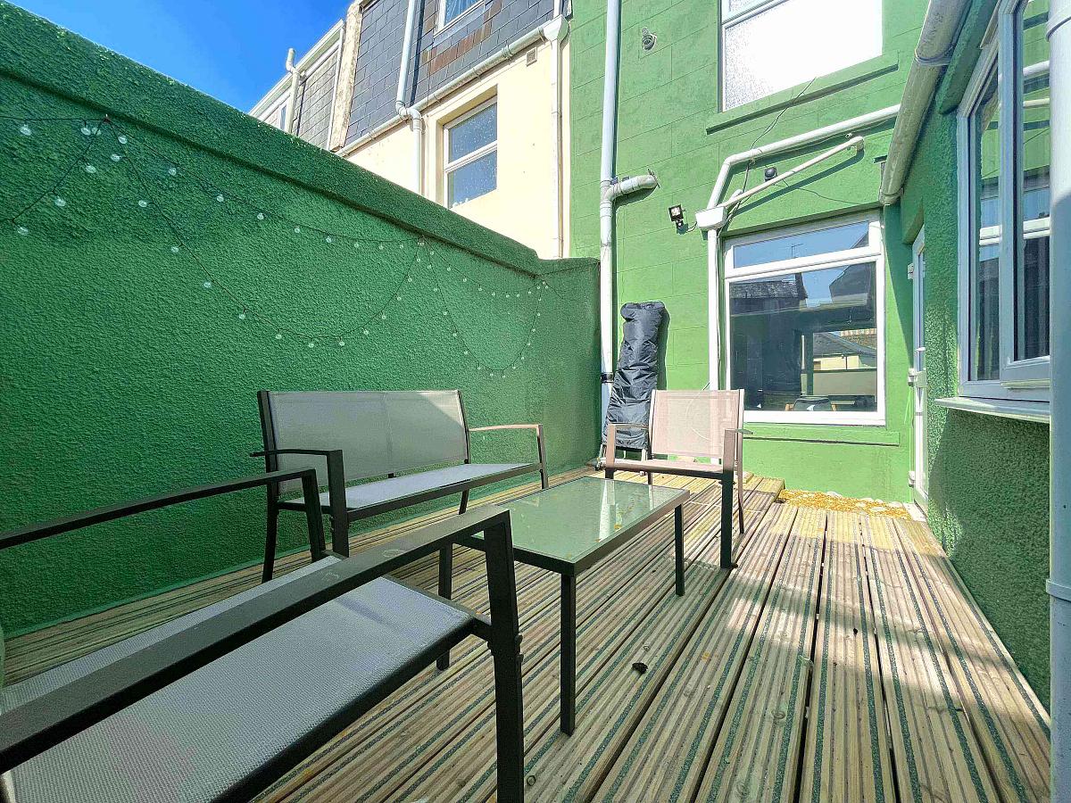 shared back garden area with decking and outside furniture