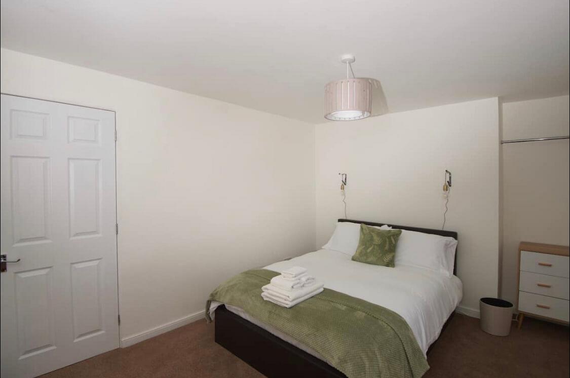 double bedroom with chest of drawers and clothes rail