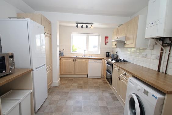 shared kitchen with cooker, dishwasher, fridge freezer and washing machine