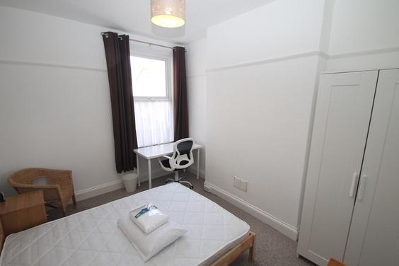 first student room double bed with desk and double wardrobe