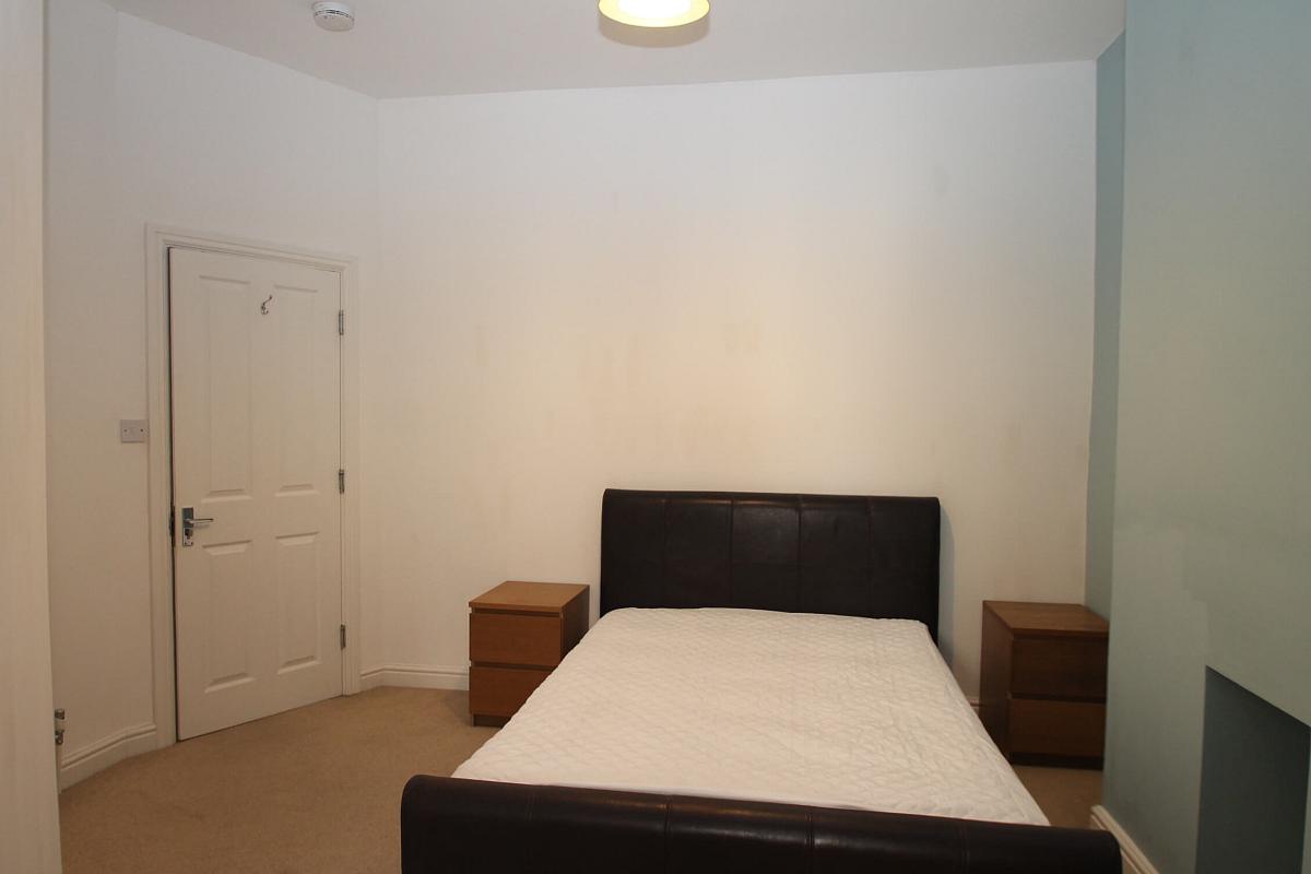 second student bedroom with double bed and two bedside tables