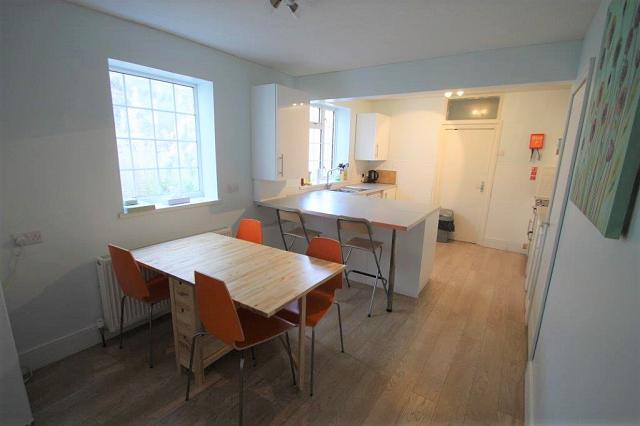 kitchen with breakfast bar and dining table with four dining chairs