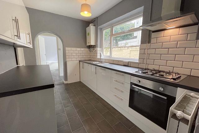 Shared kitchen with cooker and hob and hallway