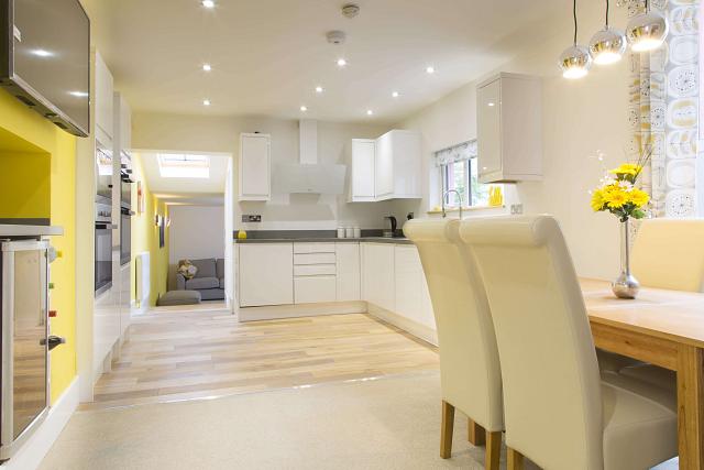 Shared kitchen and dining area leading into living area