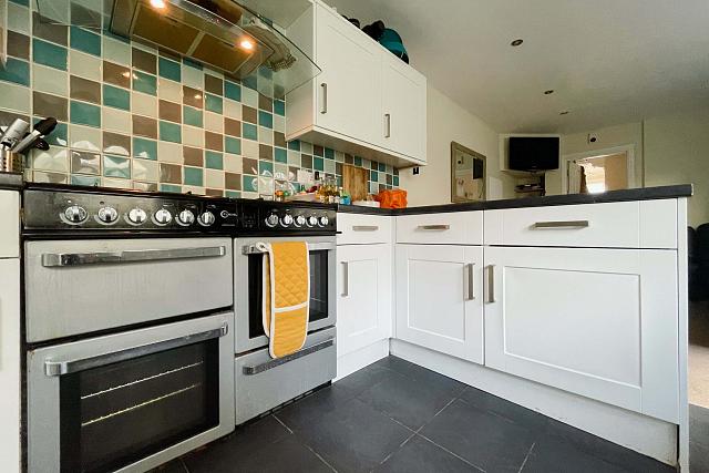 Shared kitchen with two cookers, gas hobs leading into shared living space